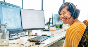 Image of an employee at their office desk