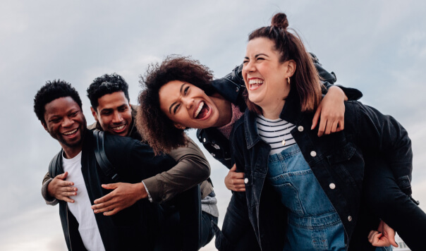 Group of friends hugging and laughing